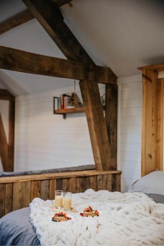 a bed with two plates of food and candles on it at Sky Cabin. Cosy Forest Log Cabin 3 night minimum in Wareham