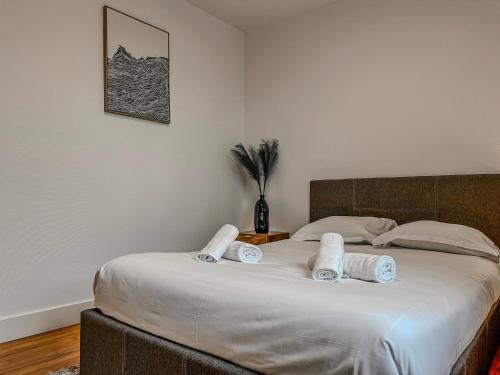 a bedroom with a large bed with two pillows on it at Le Michels - Gare - CEA - STMicro in Fontaine