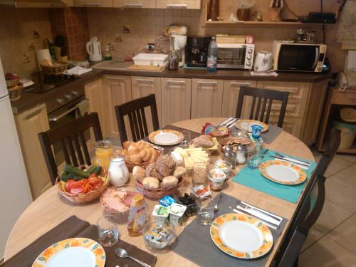 a table in a kitchen with food on it at Rami House central double rooms in Braşov