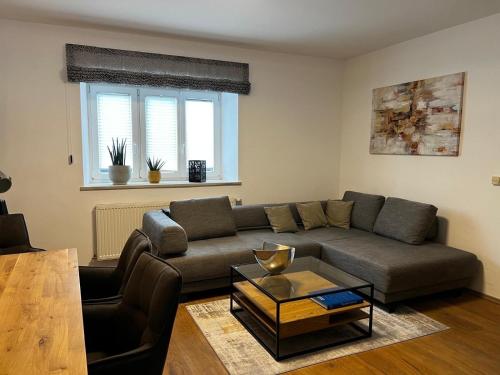 a living room with a couch and a table at Ferienwohnung Rössler in Brannenburg