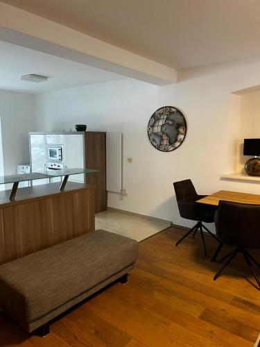 a living room with a couch and a table at Ferienwohnung Rössler in Brannenburg