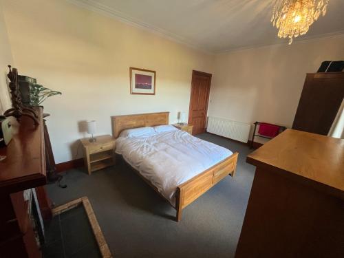 a bedroom with a bed and a desk in it at Period House Auldcastle Road Crown in Inverness