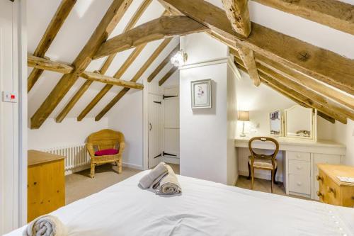 a bedroom with a white bed and a desk at 3 Bed in Stratton Strawless oc-w34832 in Stratton Strawless