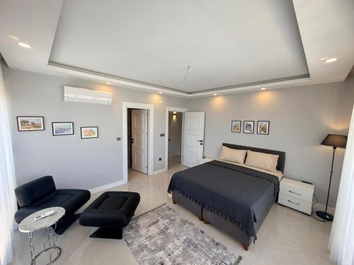 a bedroom with a bed and a table and chairs at Ephesus in Belek