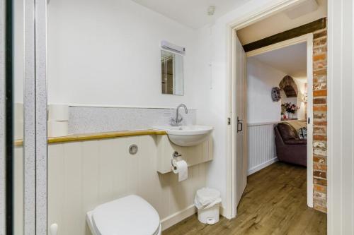 a bathroom with a sink and a toilet at 3 Bed in Stratton Strawless oc-w34832 in Stratton Strawless