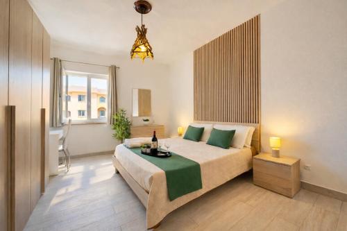 a bedroom with a bed and a large window at Demetra Seafront Apartment - Parking & Pool in Castel Volturno