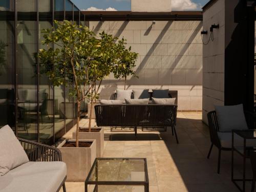 a patio with a table and chairs on a building at Hotel Stary in Krakow