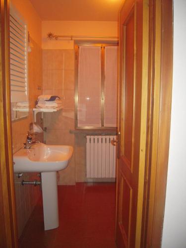 a bathroom with a sink and a shower with a window at Uliveto in Sulzano