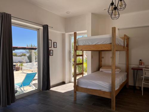a bedroom with bunk beds and a sliding glass door at The Colony La Ventana in La Ventana
