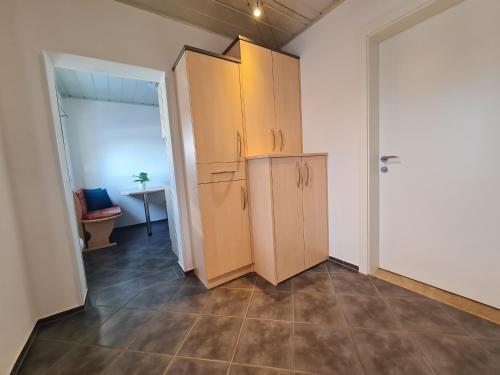 a kitchen with wooden cabinets in a room at Panorama Hof Sereinig in Sankt Oswald