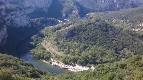 an aerial view of a river in the mountains at La chambre secrète in Aiguèze