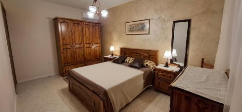 a bedroom with a bed and a dresser and a mirror at Seafront Apartment - Balcony over the Harbour in Marsaskala