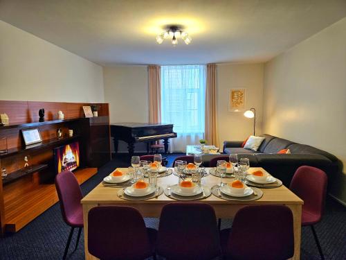 a living room with a table with wine glasses on it at Old Town Cathedral Views - Steps from Dome Square -Friends & Family stay in Riga