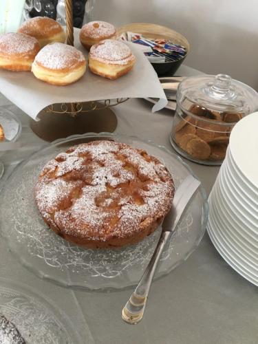 a table with a plate with a donut on it at Bell Suite Hotel in Bellaria-Igea Marina