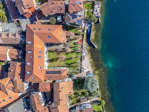 an overhead view of a village next to the water at Foresteria Monastero B&B in Mandello del Lario