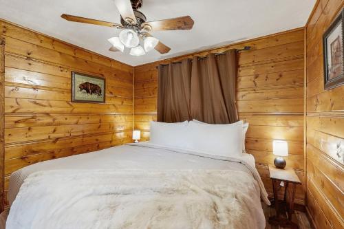 a bedroom with a bed and a ceiling fan at Bear Chalet in Bigfork