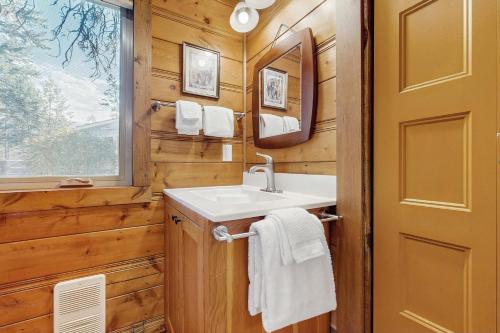 a bathroom with a sink and a mirror at Bear Chalet in Bigfork