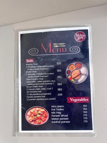 a sign for a menu on a wall at Casa Dune in Pune