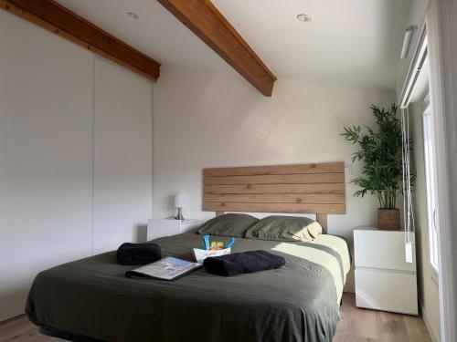 a bedroom with a bed with a bowl of food on it at Les Flots de Barzan Expérience Glamping Insolite in Barzan
