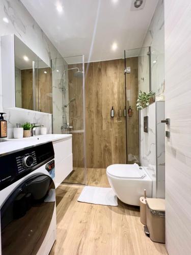 a bathroom with a tub and a toilet and a shower at Diamond D2 Iraklitsa in Iraklitsa