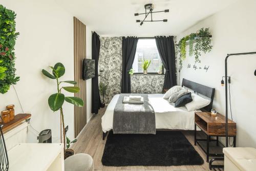 a bedroom with a bed and a window at Spacious and modern flat in Archway in London