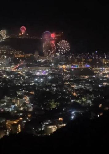 a view of a city at night with fireworks at Hotelcasacecinn in San José del Cabo