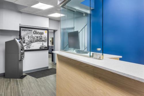 an office cubicle with a tv and a counter at Super 8 by Wyndham Chicago IL in Chicago