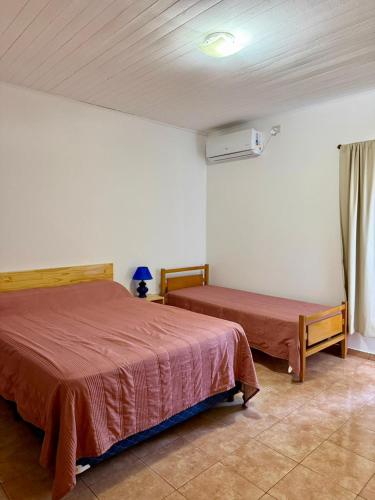 a bedroom with two beds in a room at Departamentos MR in Villa Elisa
