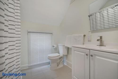 a white bathroom with a toilet and a sink at The Melrose in Ocean Grove