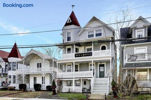 a row of white houses with steep roofs at The Melrose in Ocean Grove