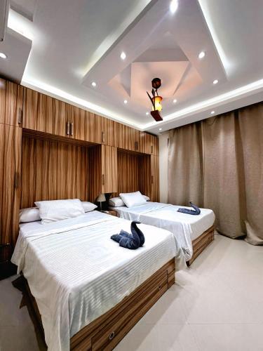 a bedroom with two beds and a ceiling at Sharm Hills Azure Paradise in Sharm El Sheikh