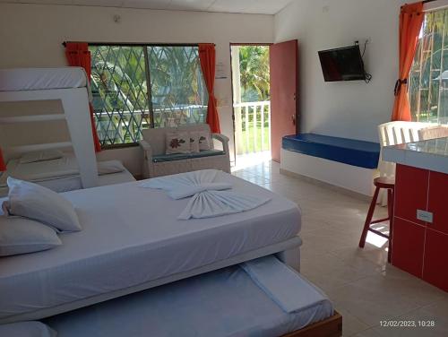 a bedroom with two bunk beds and a balcony at Cabanas Recreaciones in Coveñas