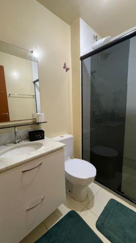 a bathroom with a toilet and a sink and a shower at Apartamento vita bella in Porto Velho