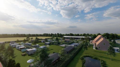 an aerial view of a farm with buildings and trees at Minicamping Ons Weitje in Koudekerke