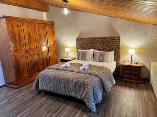 a bedroom with a large bed and two night stands at Casa Marèlia, Costa Daurada Rural in Vilanova de Escornalbou