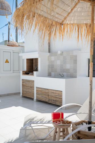 a kitchen with white cabinets and a table and chairs at Villa Pastida - Boutique Luxury Villa on Rhodes with Private Pool in Pastida