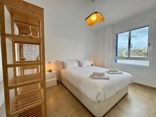 a bedroom with a bed and a wooden ladder at Lancón Boutique- Precioso apartamento a 150 m a pie de playa Lancón- Carboneras in Carboneras