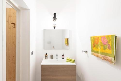 a bathroom with a sink and a mirror at Corina Secret Rooms in Martano