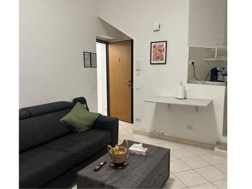 a living room with a couch and a table at Fiore Apartments in Fiorenzuola dʼArda