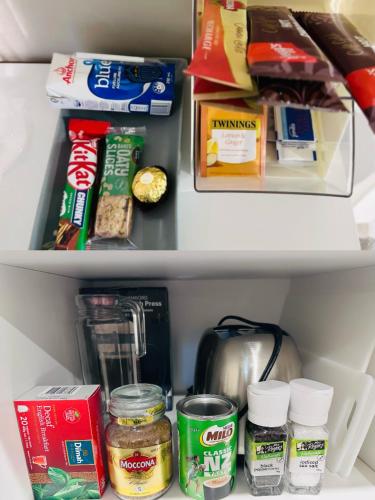 a refrigerator filled with food and other food items at Large 1BR Suite and Private Lounge in Tauranga