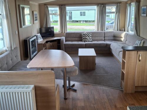 a living room with a couch and a table at Glasyln 37 in Porthmadog