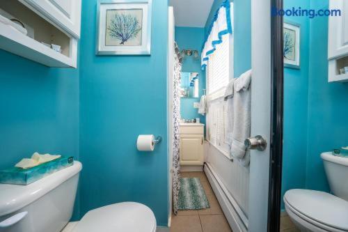 a blue bathroom with a toilet and a sink at The Allenhurst in Ocean Grove