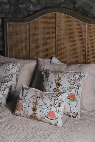 a bed with two pillows and a headboard with at La Casina de Isoba in Isoba
