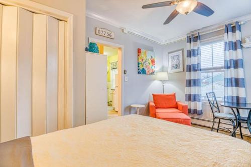 a bedroom with a bed and a chair and a table at The Allenhurst in Ocean Grove