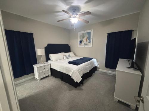 a bedroom with a bed and a ceiling fan at The Burnham in Oxford