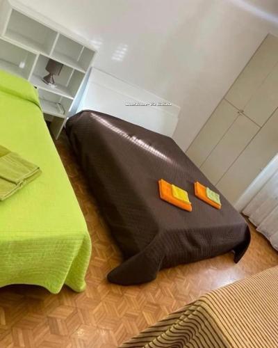 a black blanket laying on the floor next to a bed at da Lilia in Salute&Bellezza Business Apartment in Monfalcone
