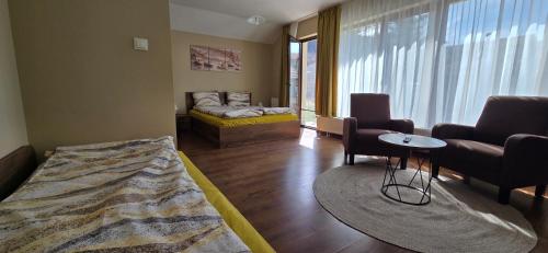 a living room with a bed and a couch at Къща за гости Гергана in Ribarica