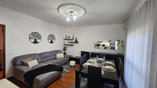 a living room with a couch and a table at Varanda da Gardunha - Alojamento Local in Fundão