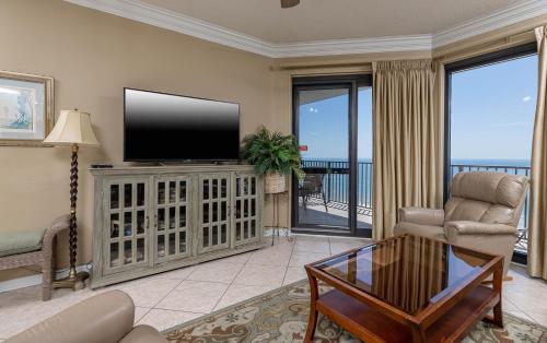 a living room with a flat screen tv on a entertainment center at Phoenix VI 61509 in Orange Beach