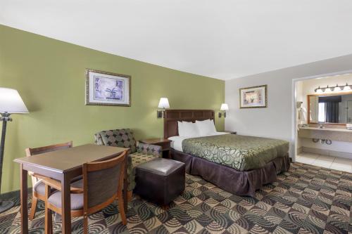 a hotel room with a bed and a desk at Best Western Caprock Inn in Brownfield